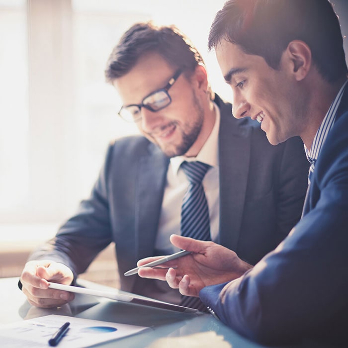 Businessmen looking at a tablet